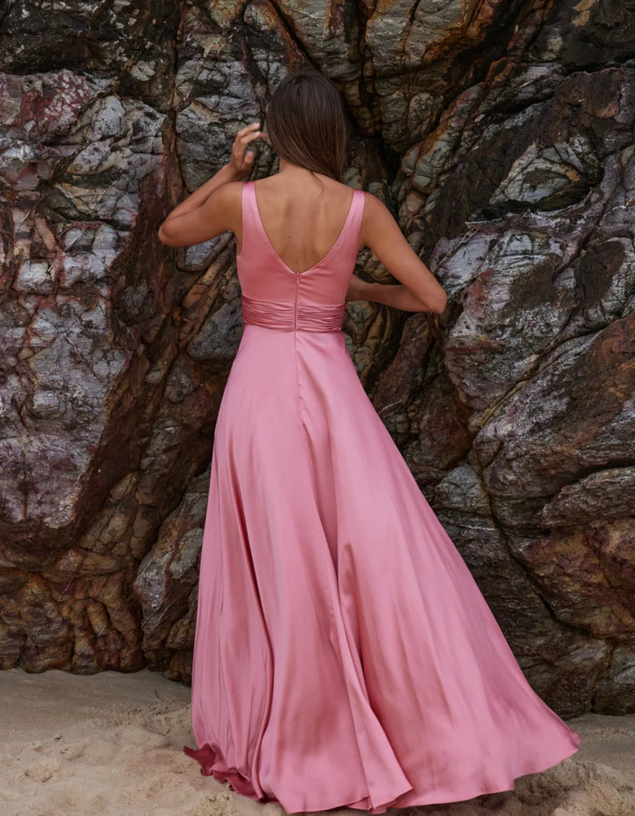 Back view of sakura gown with V-backline and ruched waistband with full-length skirt in pink satin fabric