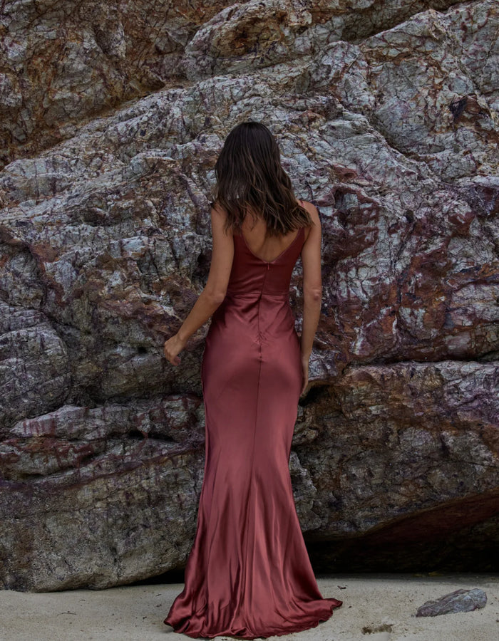 Back view of Misty bridesmaid dress in rust colour satin-look fabric. Full length dress with centre back zip closure