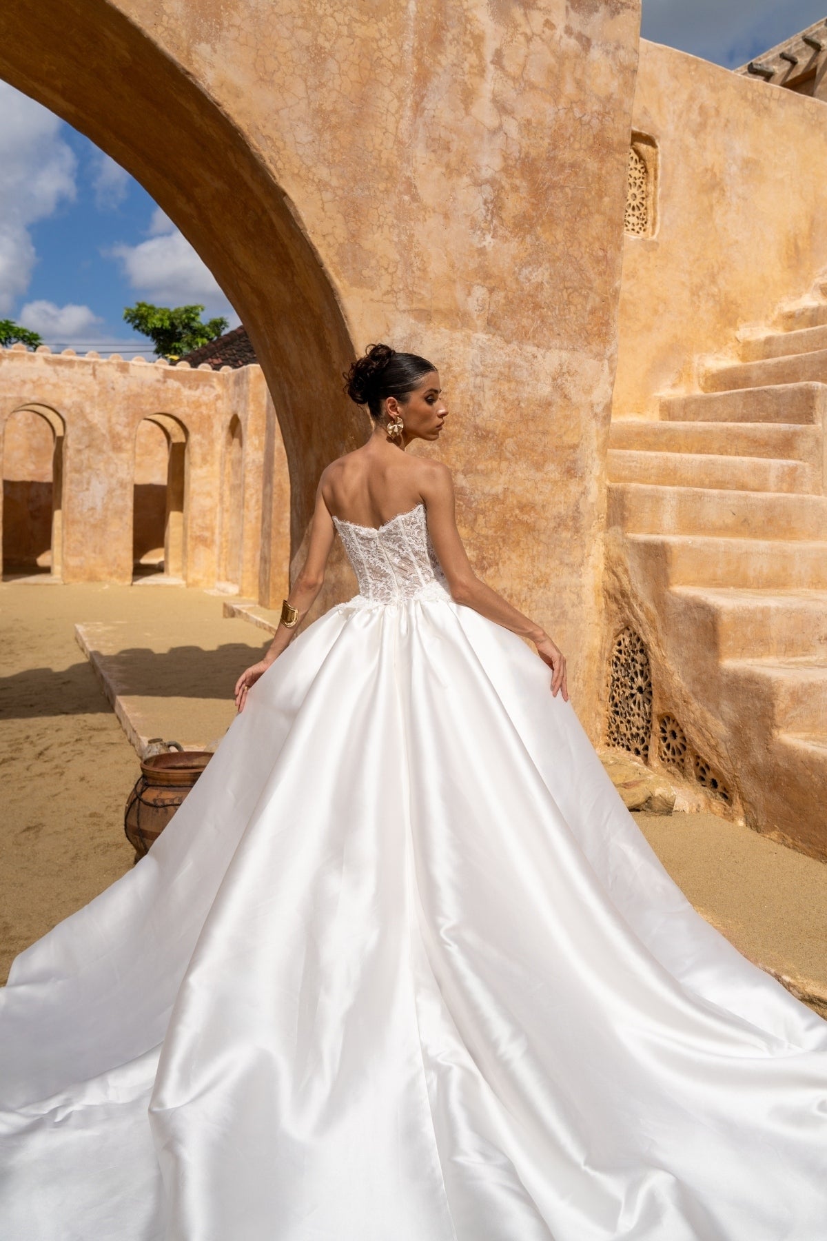 A-line wedding gown with lace bodice and plain skirt featuring basque waistline 