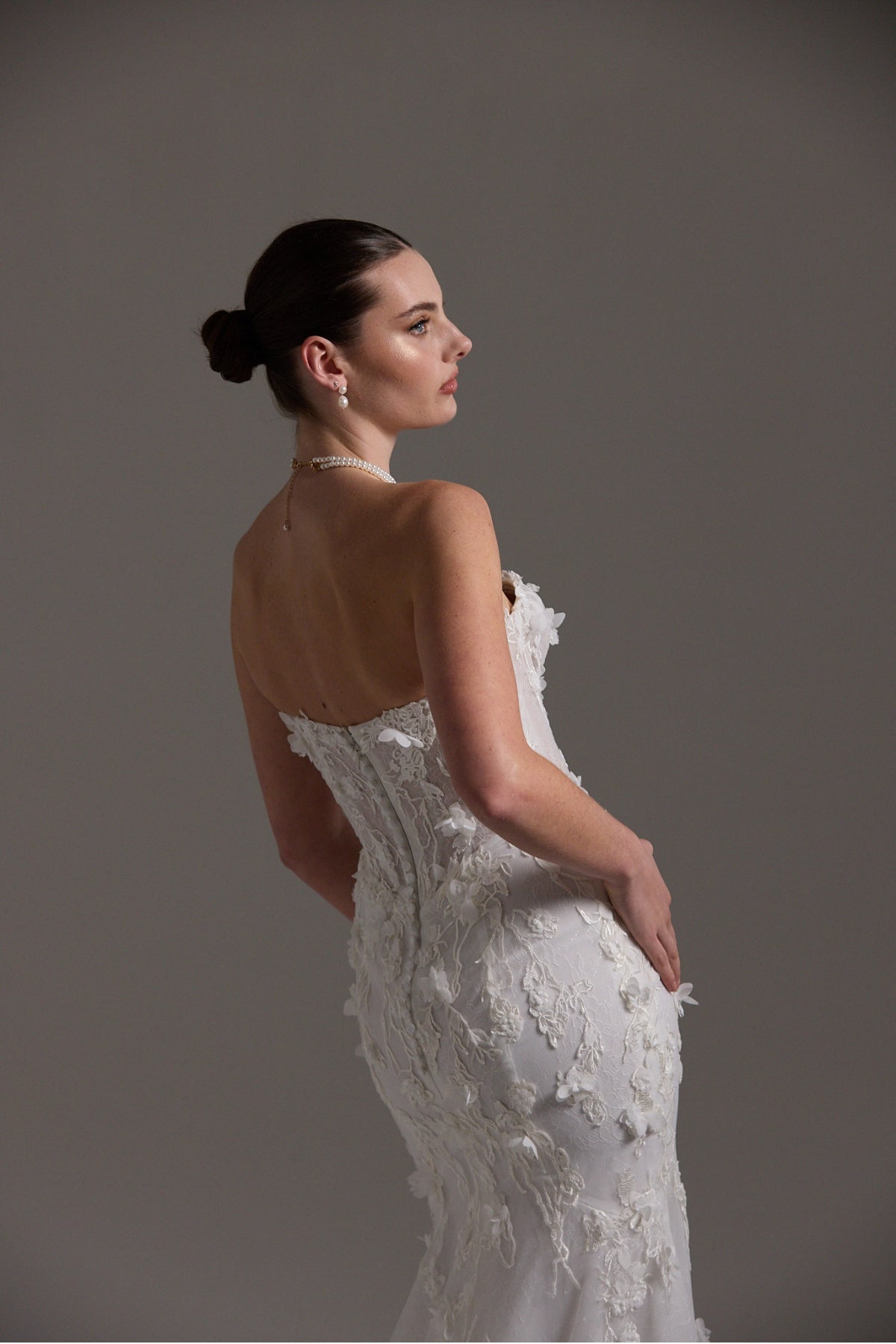 Fitted bridal gown with floral lace and strapless neckline 