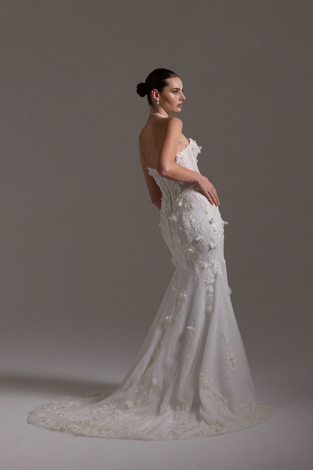 Fitted bridal gown with floral lace and strapless neckline 