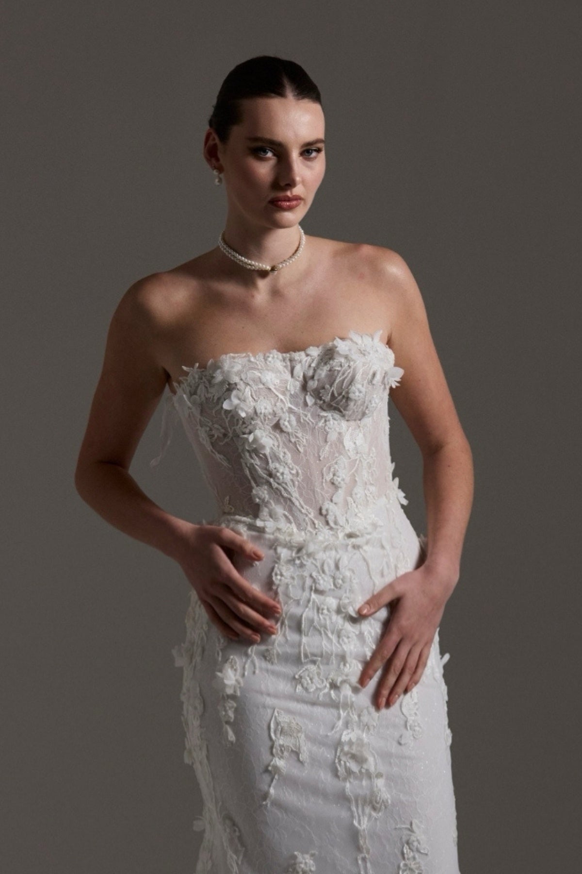 Fitted bridal gown with floral lace and strapless neckline 