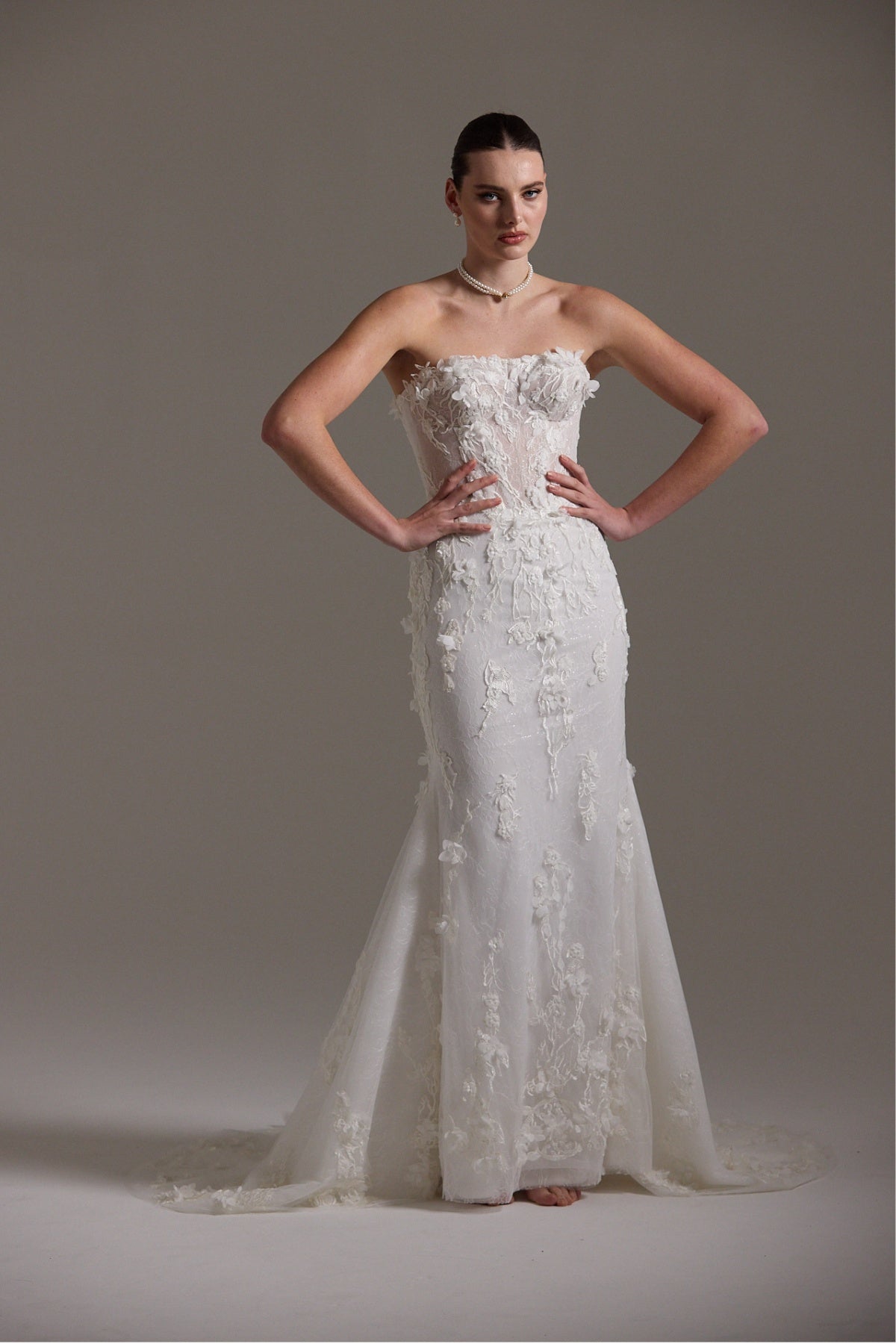 Fitted bridal gown with floral lace and strapless neckline 