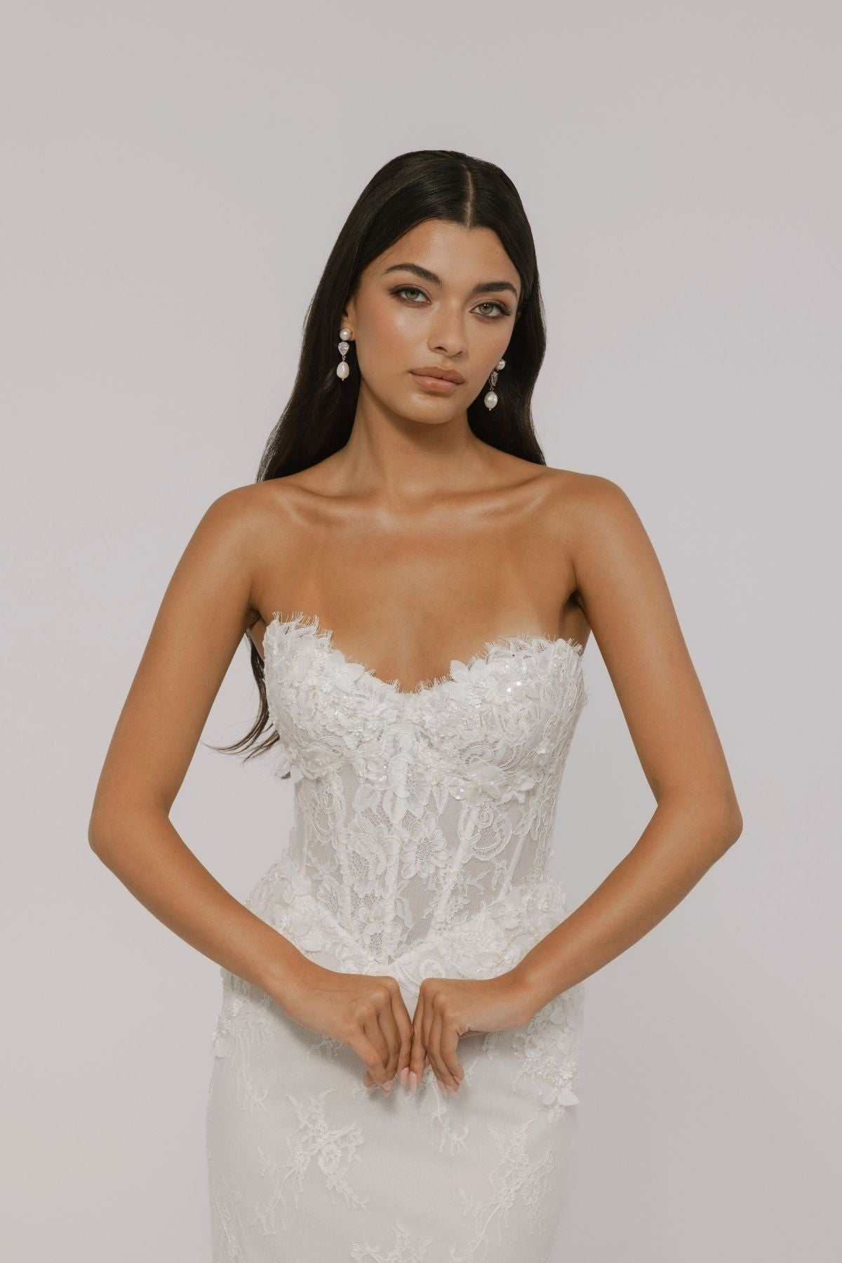 sweetheart neckline fitted wedding gown featuring basque waist and corset boning, with floral lace. 