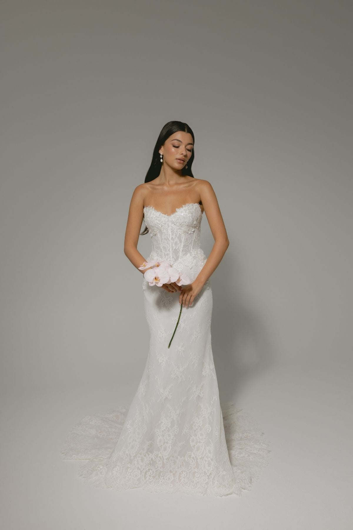 sweetheart neckline fitted wedding gown featuring basque waist and corset boning, with floral lace. 