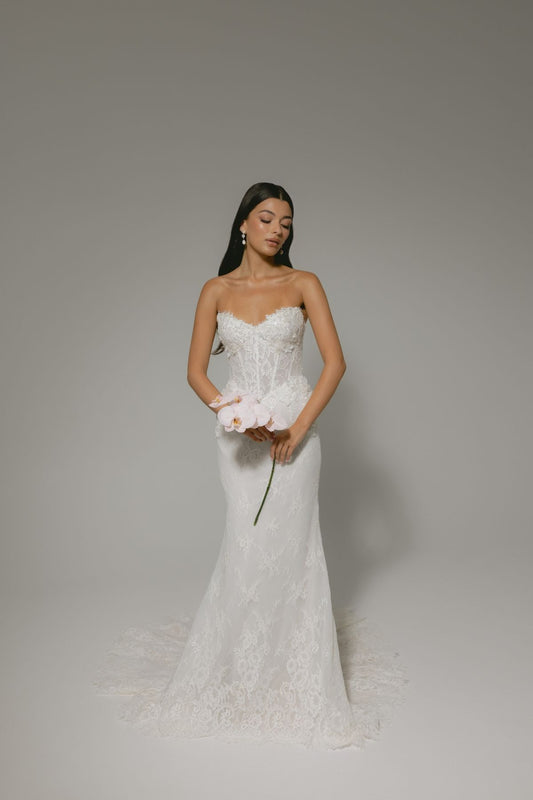 sweetheart neckline fitted wedding gown featuring basque waist and corset boning, with floral lace. 