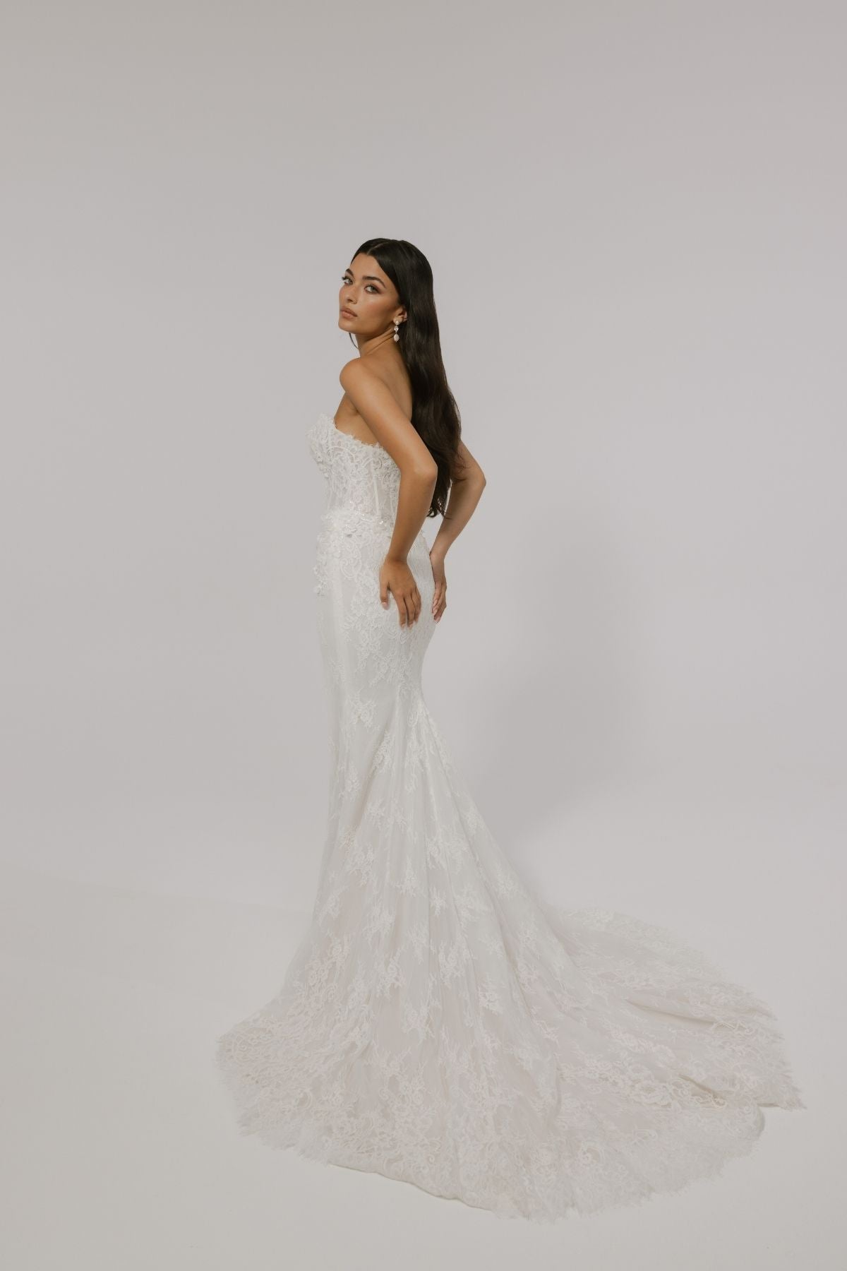 sweetheart neckline fitted wedding gown featuring basque waist and corset boning, with floral lace. 