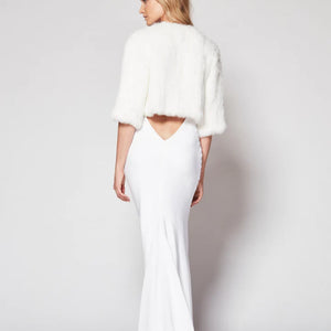 Back view of Laci fur jacket in snow. 3/4 Sleeves and cropped waist