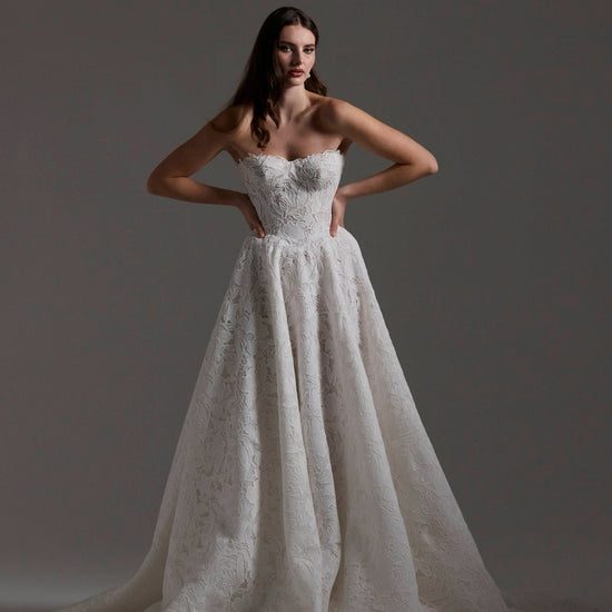 A-line Wedding dress in floral Jacquard fabric with fitted sleeves and a strapless bodice 