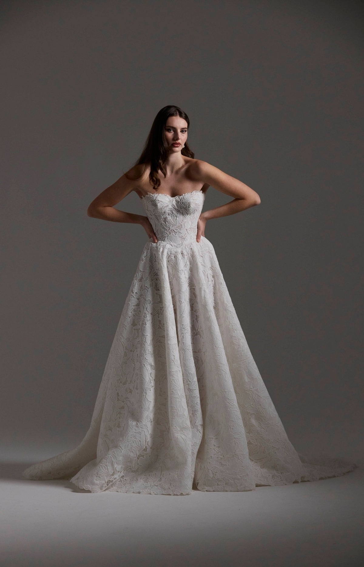 A-line Wedding dress in floral Jacquard fabric with fitted sleeves and a strapless bodice 