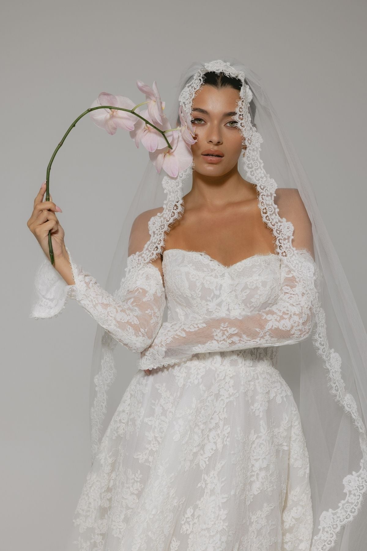 Lace A-line wedding gown with off the shoulder sleeves, dramatic chapel train 