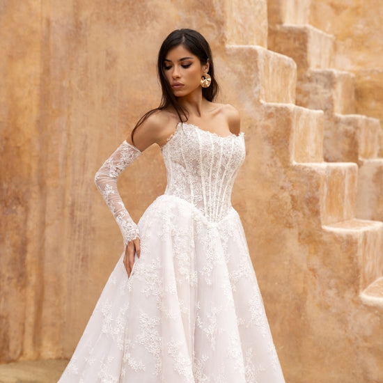 Lace A-line wedding dress with cat-eye neckline and basque waist. paired with fitted lace sleeves. 