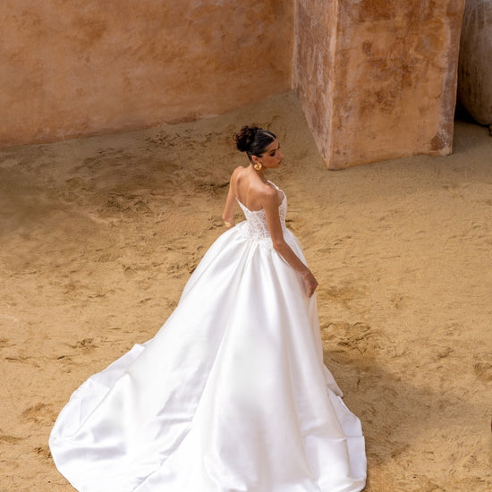 A-line wedding gown with lace bodice and plain skirt featuring basque waistline 