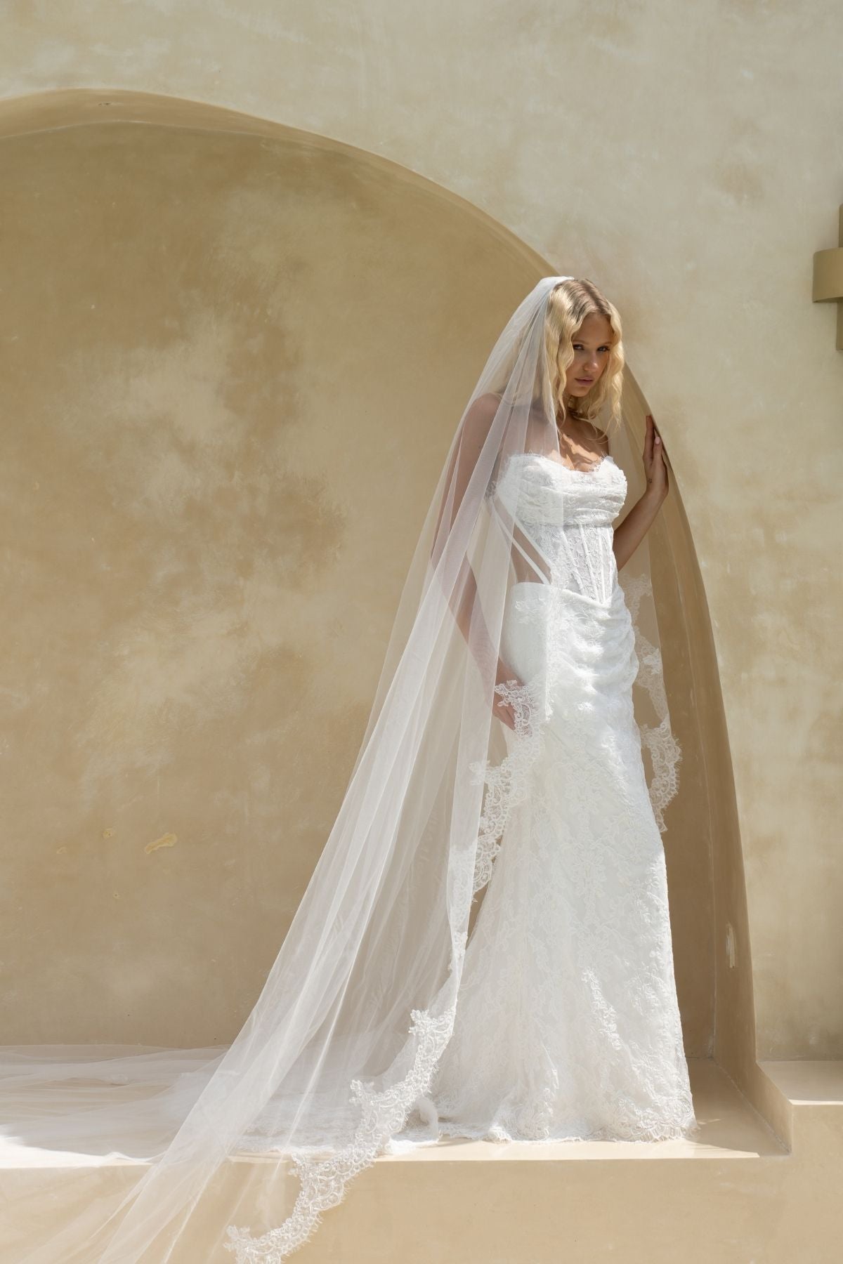 fitted lace wedding gown with ruched bust, sweetheart neckline, and sheer side cut outs with corset boning. featuring a slight basque waist