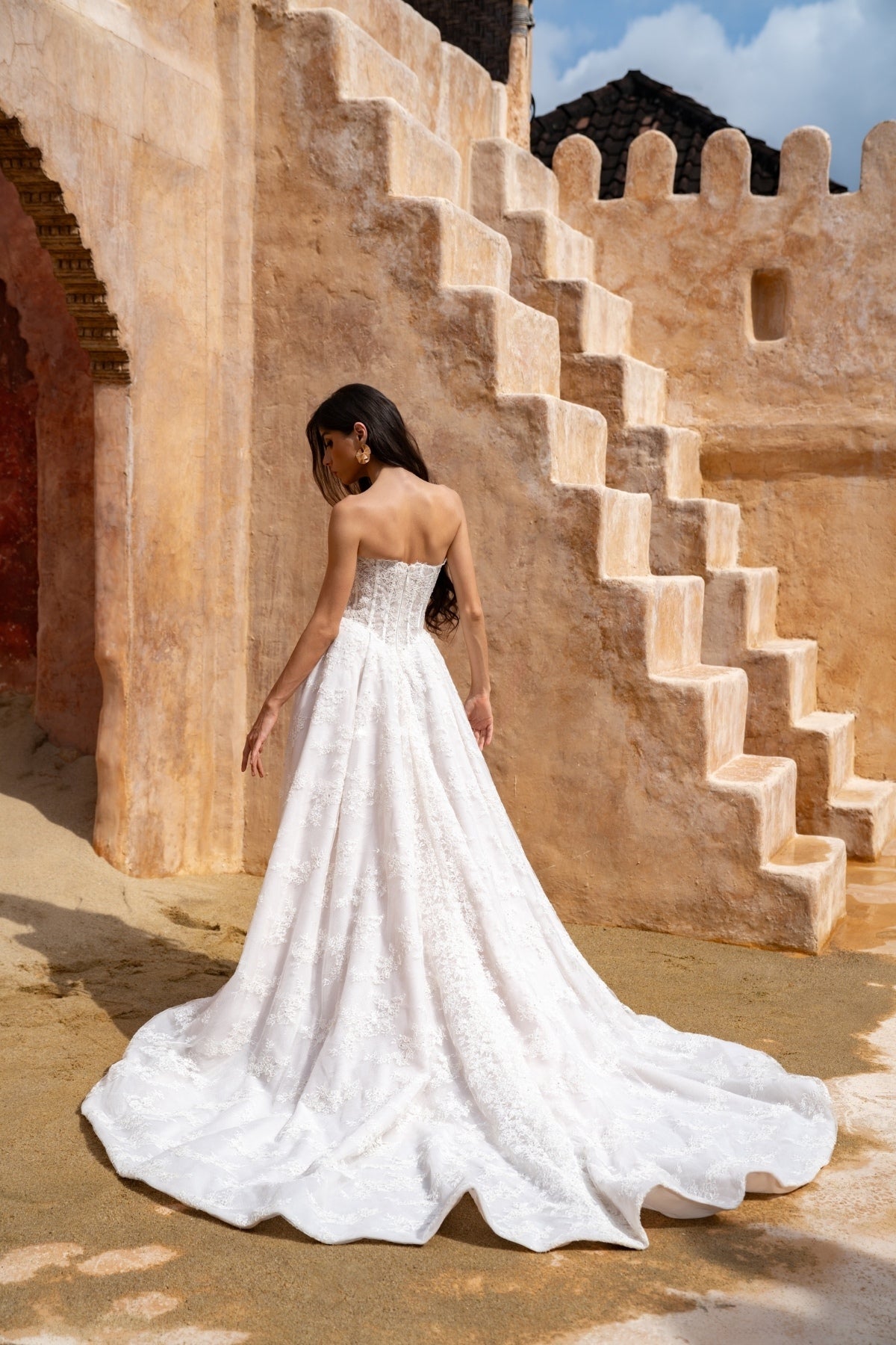 Lace A-line wedding dress with cat-eye neckline and basque waist. paired with fitted lace sleeves. 