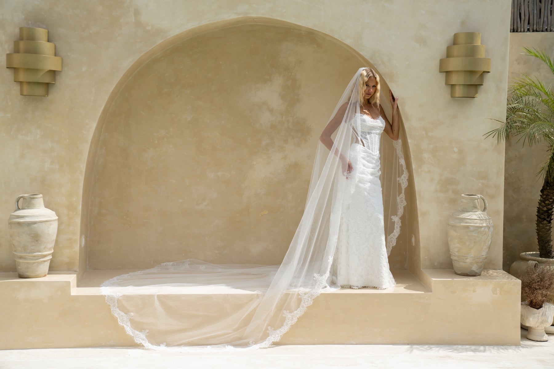 fitted lace wedding gown with ruched bust, sweetheart neckline, and sheer side cut outs with corset boning. featuring a slight basque waist