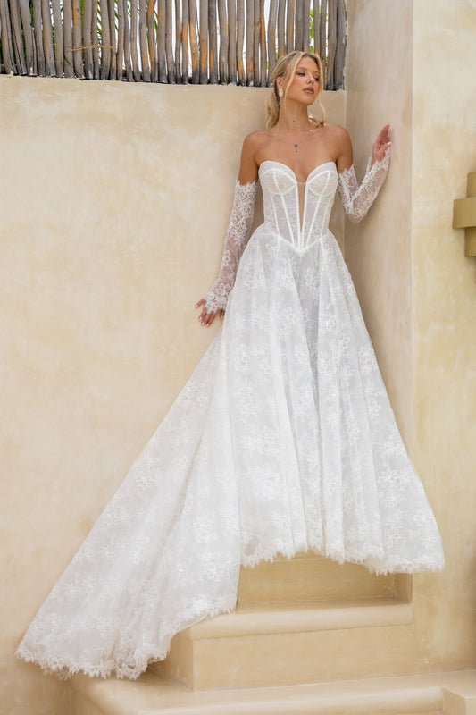 Lace A-line wedding gown with deep v plunge and sweetheart neckline, basque wasitline and fitted lace sleeves. 