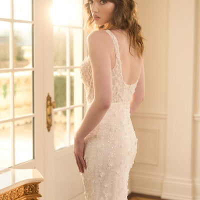 Side view of Kristy. Figure-hugging fit-n-flare style with 3D florals and beads. Plunging back that sits above waistline.