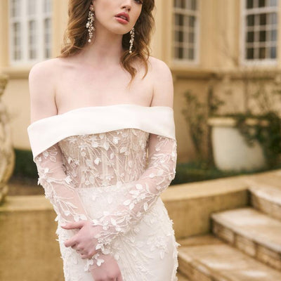 Close up of Theia bodice with sleeves. 3D floral lace climbs down arms, bodice and top of skirt. Ivory off the shoulder band.
