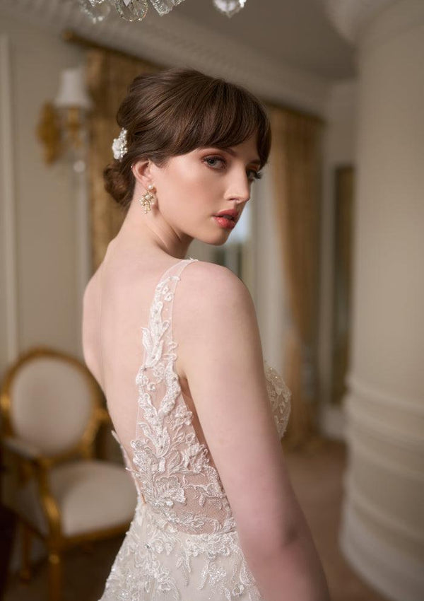 Back view of Tilly bodice with leafy embroidered lace stitched with pearls and beads. Plunging V back that meets at the waist with A-line skirt.