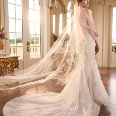 Back view of Taya dress showing train with veil billowing over.