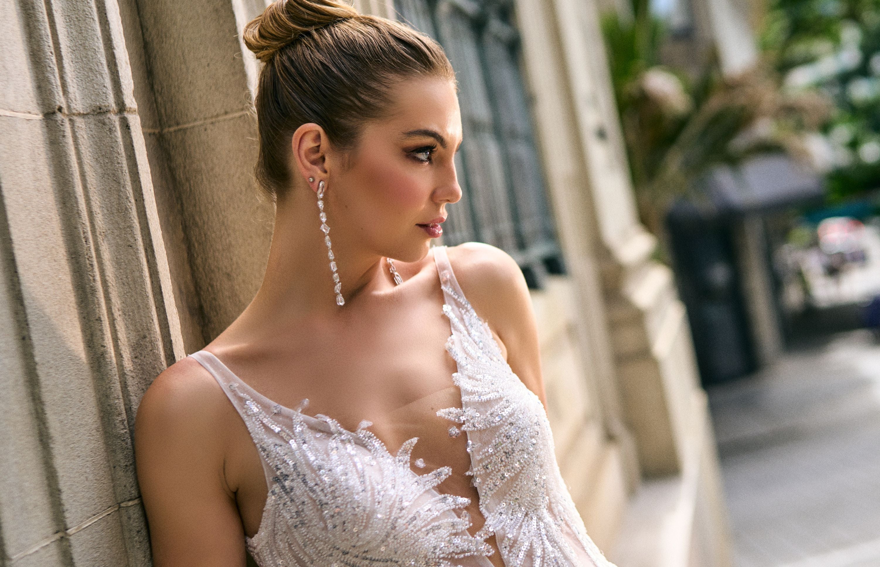 Close up of plunging front neckline. Illusion mesh neckline with sequined and beaded lace over top.