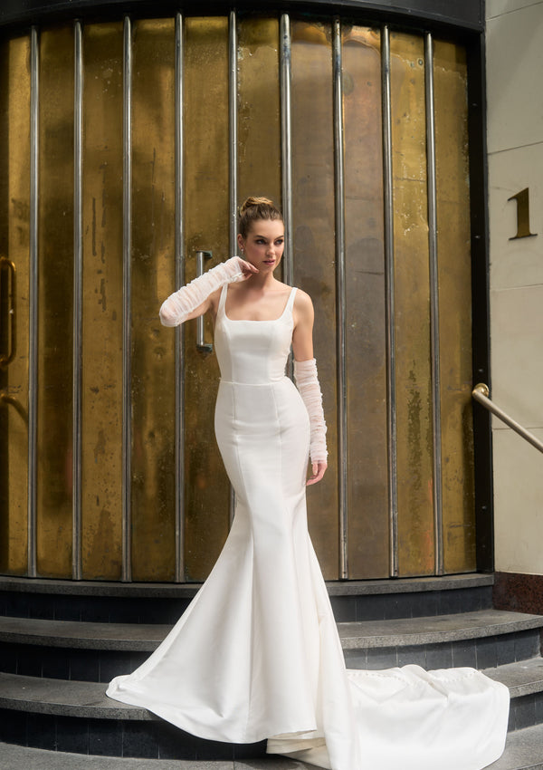 Ivory mikado minimalist gown with rouched tulle separate sleeves. Fit-n-flare shape with square neckline.