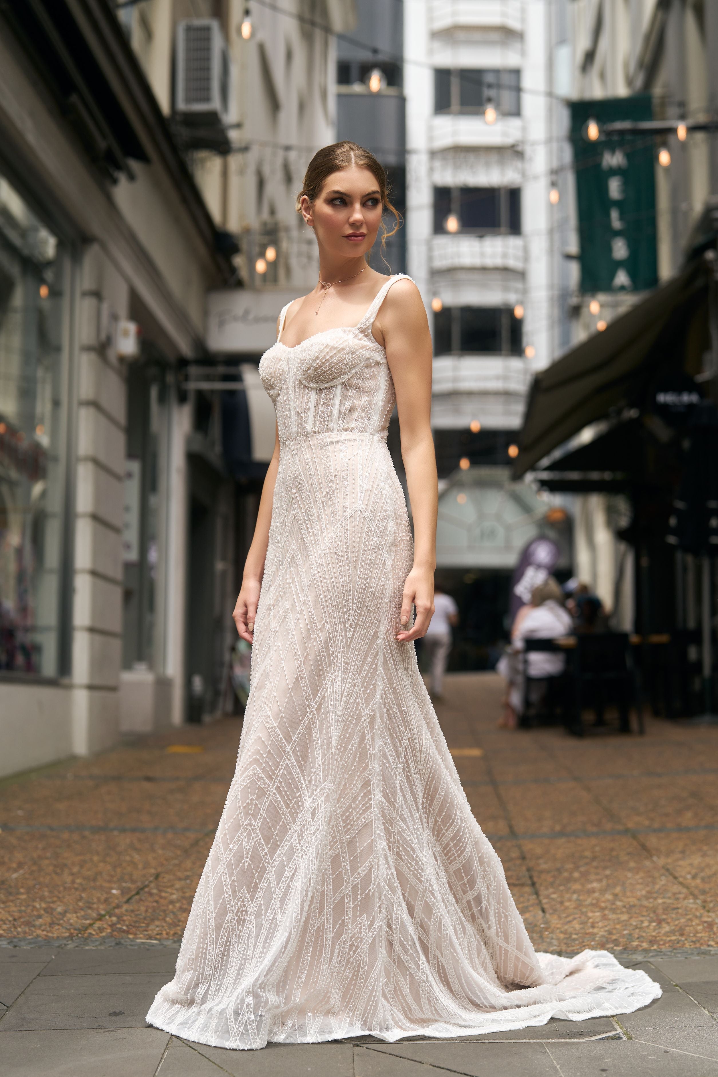 Fashioned with beaded lace, this fit-n-flare gown features a square neckline and fully boned bodice and beaded straps.