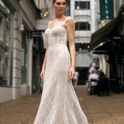 Fashioned with beaded lace, this fit-n-flare gown features a square neckline and fully boned bodice and beaded straps.