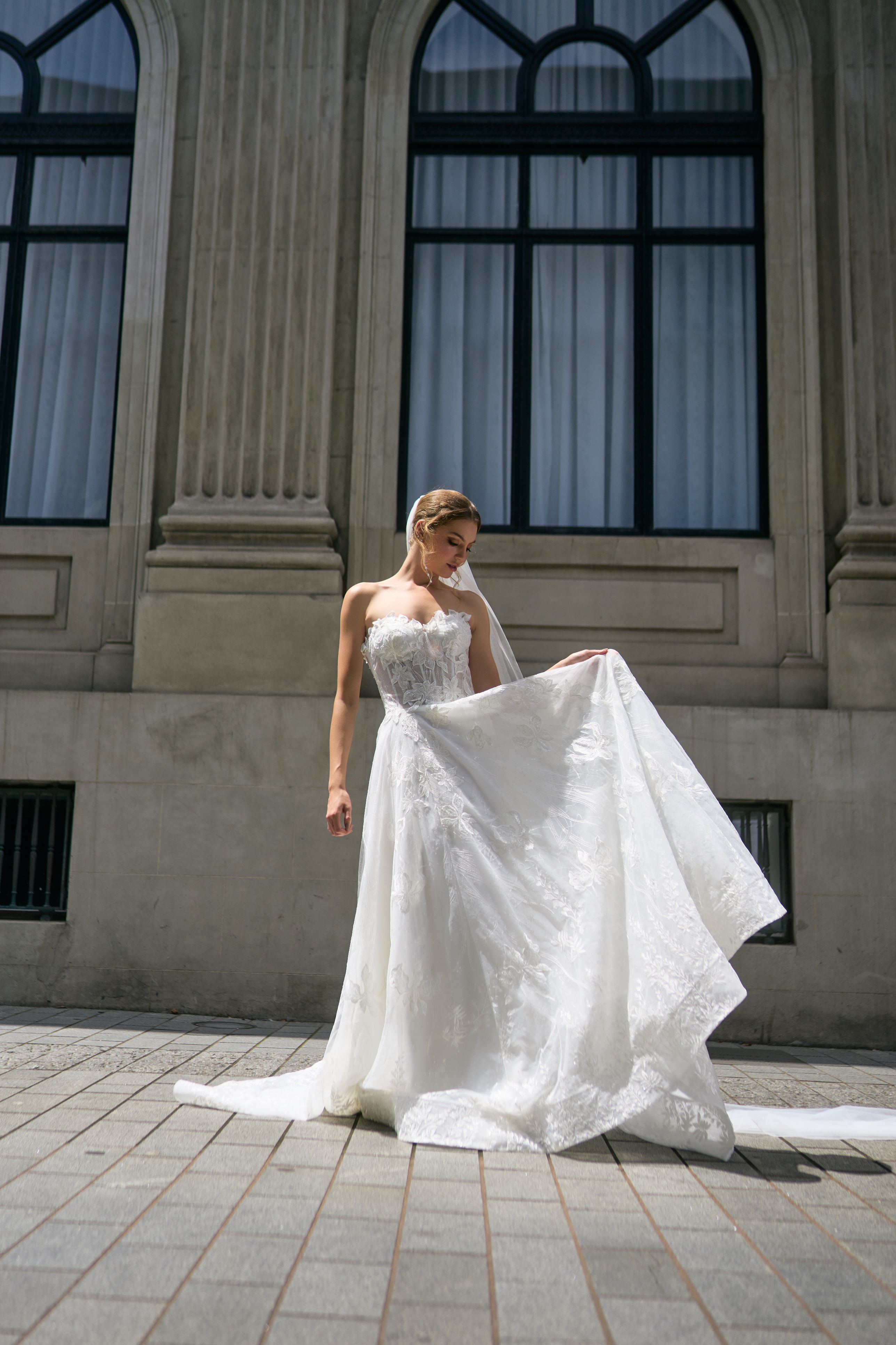 Renee wedding dress with unique A-line silhouette, crafted in floral fabric. Strapless design cinches at the waist for support at the décolletage. Flowy skirt adds lightness and luxury to the dress.