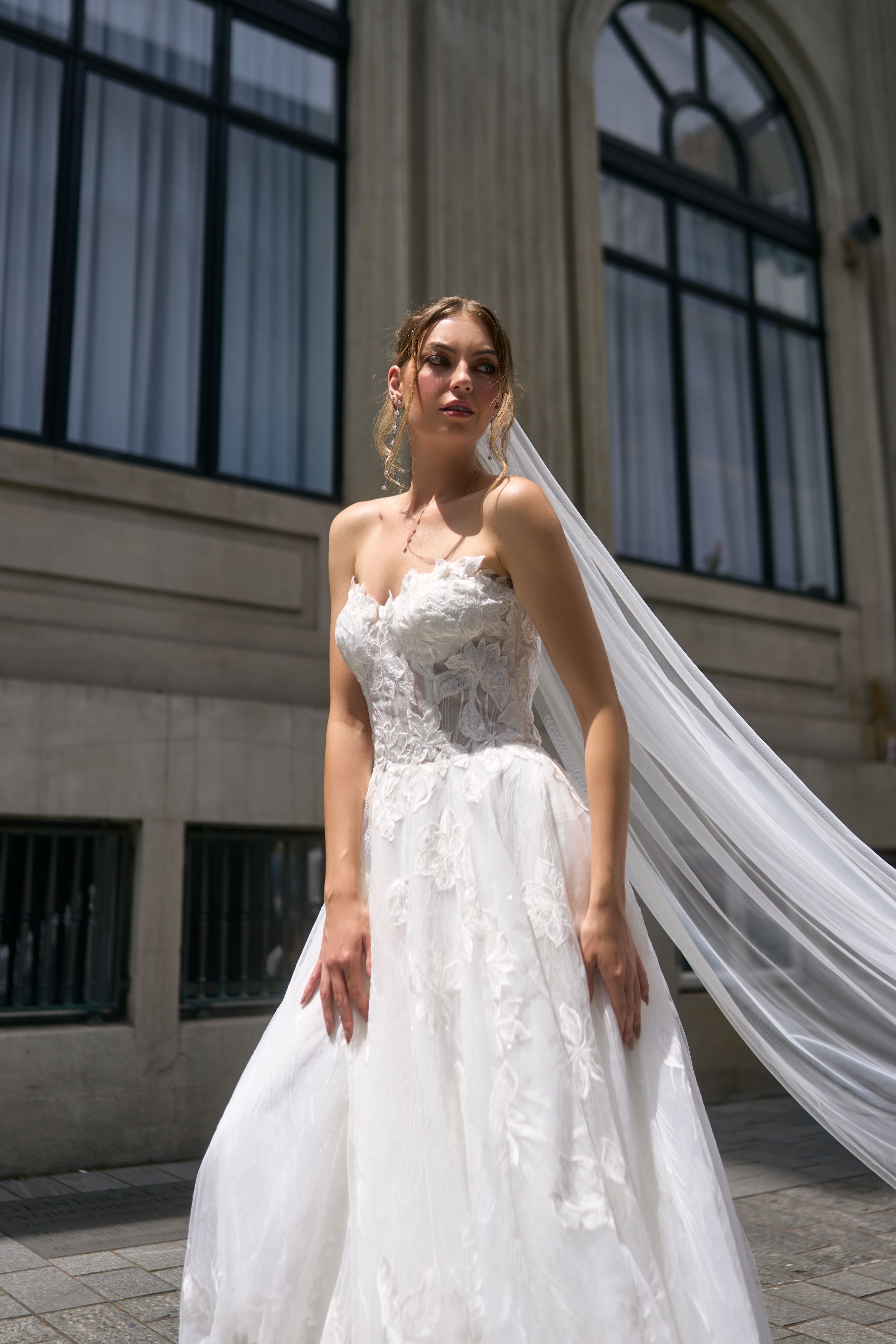 Renee wedding dress with unique A-line silhouette, crafted in floral fabric. Strapless design cinches at the waist for support at the décolletage. Flowy skirt adds lightness and luxury to the dress.