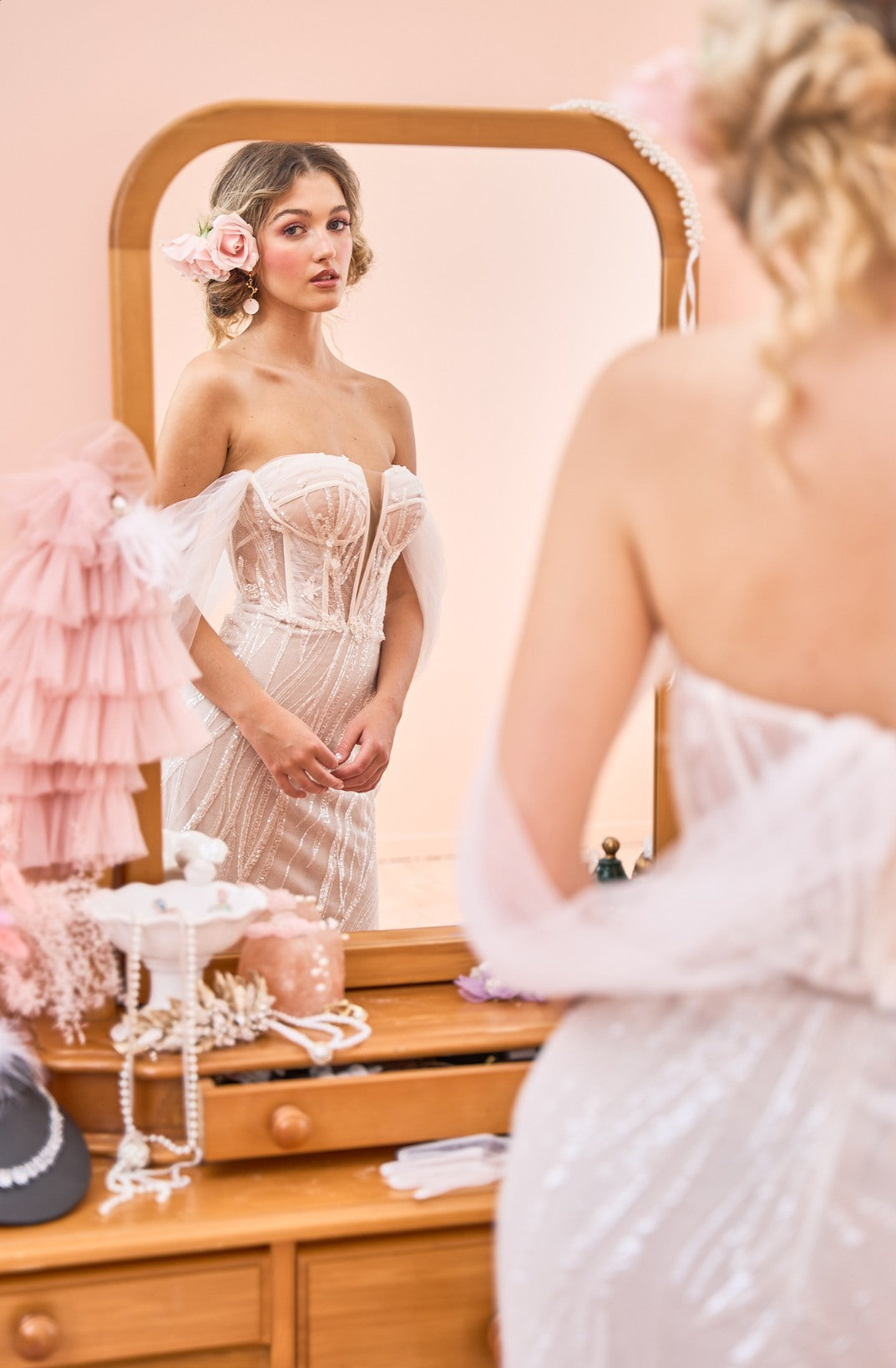 Model wearing fit-n-flare Sierra wedding dress with tulle off-shoulder sleeves from the Mademoiselle collection