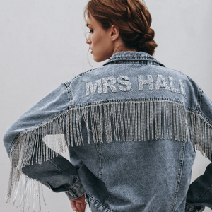 Back view of blue denim jacket with diamante fringe and lettering reading 'MRS HALL'