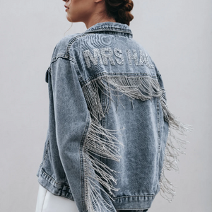 Side view of blue denim jacket with diamante fringe reading 'MRS HALL'