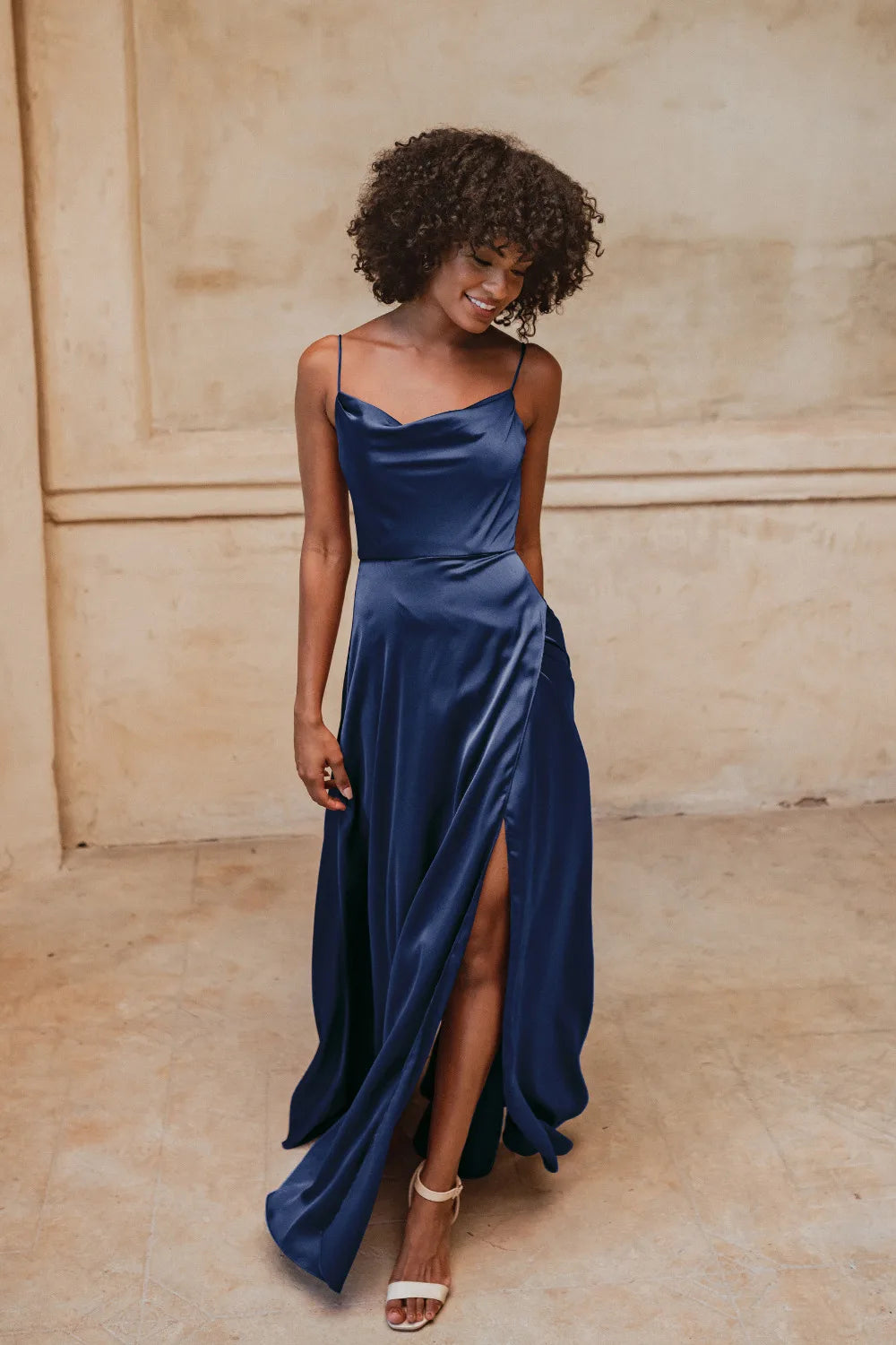 Cowl neck satin bridesmaid dress in peacock blue. Full length skirt from waist with split.