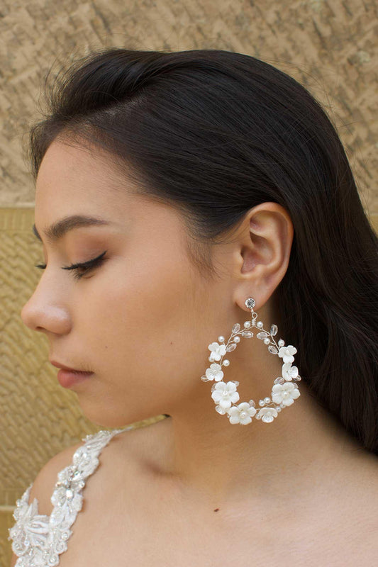 White clay flowers on silver hoop earrings hanging from diamante stud