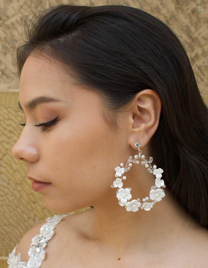 White clay flowers on silver hoop earrings hanging from diamante stud