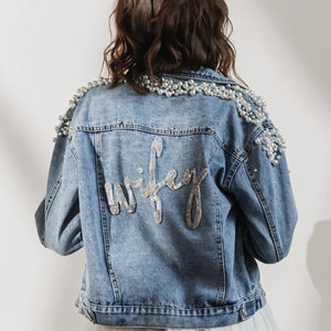Blue denim jacket with pearl beads encrusted on shoulders and 'wifey' beaded on back