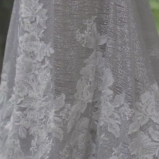 Model wearing Nessie silver and ivory lace wedding gown