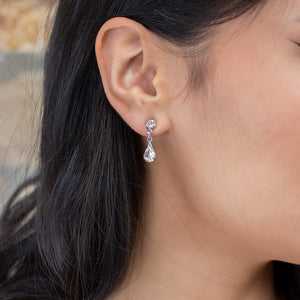 Narrow dangly earring of round and teardrop cubic zirconia.